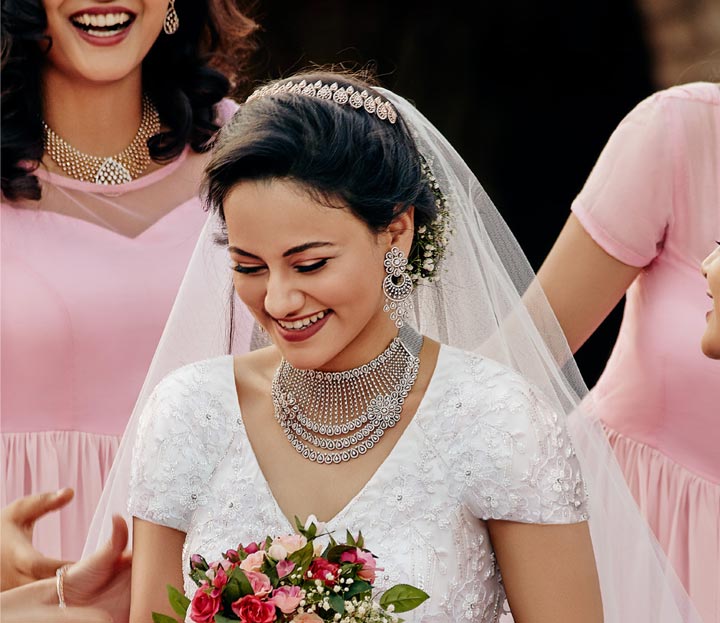 Gorgeous Smiling Bride With His Bridemaids In White Gown With Bouquet In Hands.